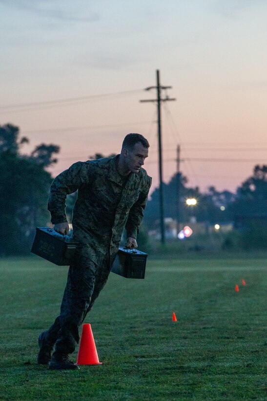 U.S. Marine Corps Capt. Kevin Zimmerman, a Sellersville, Pennsylvania, native and an infantry officer with 3rd Battalion, 2d Marine Regiment, 2d Marine Division, conducts a run with ammo cans  during the Division Leader Assessment Program 4-22 on Camp Lejeune, North Carolina, Sept. 7, 2022. The assessment program  provides Marines with learning and mentorship opportunities, which helps train and develop Marines that demonstrate an apex level of lethality, endurance and comprehensive warfighting ability. (U.S. Marine Corps photo by Lance Cpl. Ryan Ramsammy)