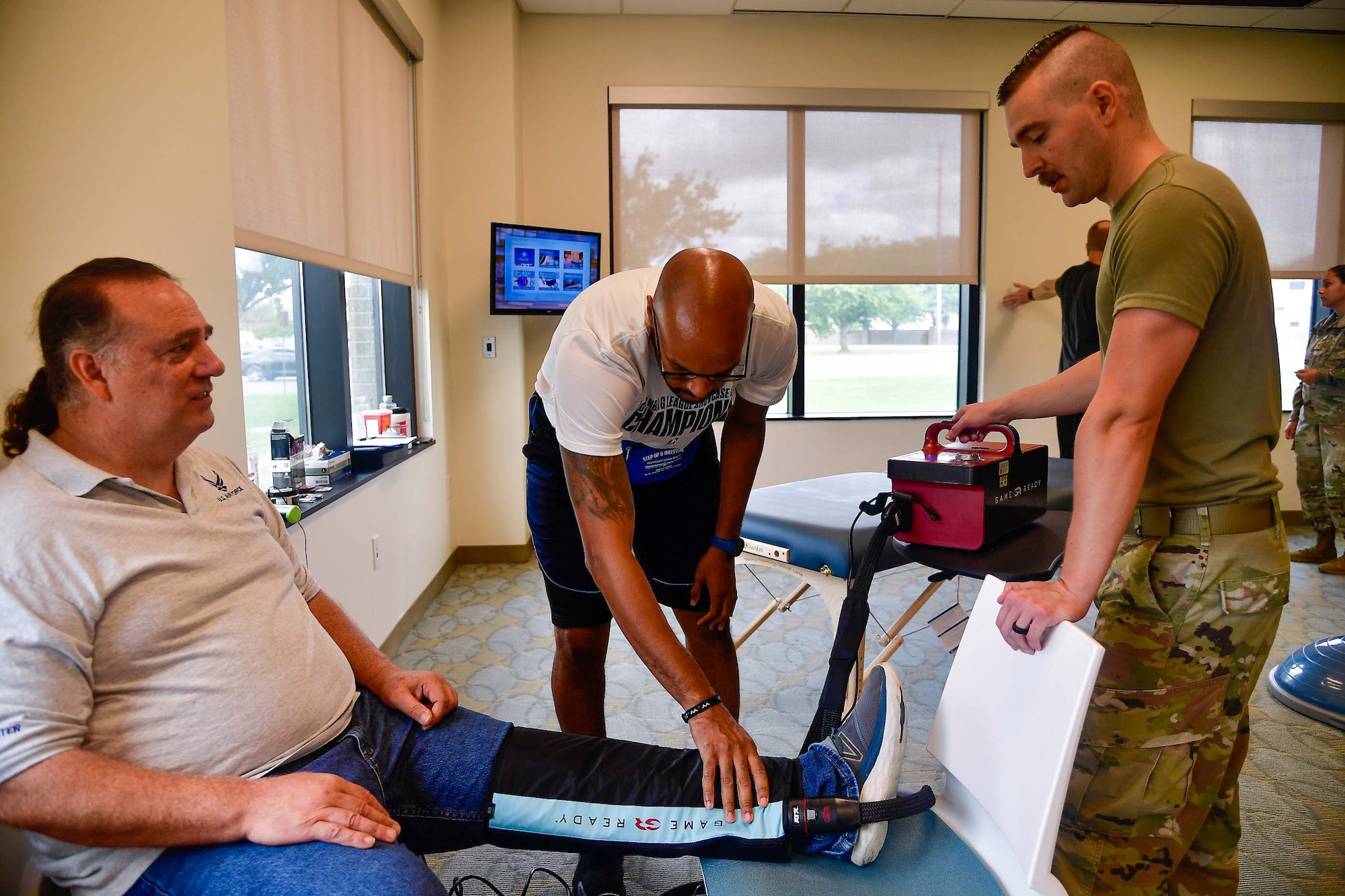 Airmen from the 436th Operational Medical Readiness Squadron use a cold compression machine during the Human Performance and Wellness Event at Dover Air Force Base, Delaware, Sept. 8, 2022. Hosted by the 436th OMRS human performance flight, the event featured walk-in physical therapy appointments, glucose tests, a running clinic and booths from agencies around base. (U.S. Air Force photo by Senior Airman Faith Barron)