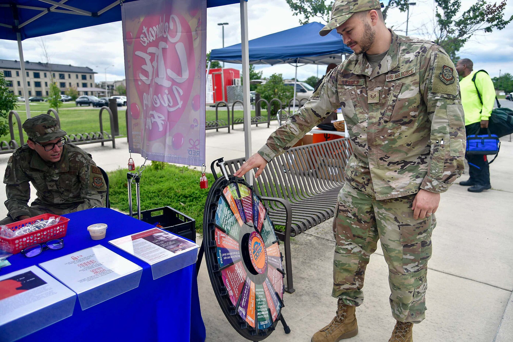 Staff Sgt. Seth Lanham, 9th Airlift Squadron flight engineer, spins a trivia wheel at the Drug Demand Reduction Program booth at the Human Performance and Wellness Event on Dover Air Force Base, Delaware, Sept. 8, 2022. Hosted by the 436th OMRS human performance flight, the event featured walk-in physical therapy appointments, glucose tests, a running clinic and booths from agencies around base. (U.S. Air Force photo by Senior Airman Faith Barron)