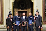 Lt. Cmdr. Samuel Pemberton (left), Petty Officer 2nd Class James Peragine, and Lt. Cmdr. Matthew Van Ginkel, the Endgame59 aircrew, received the U.S. Interdiction Maritime Interdiction Award Feb. 18, 2022, for their successful interdiction mission in August 2021. (USCG photo)