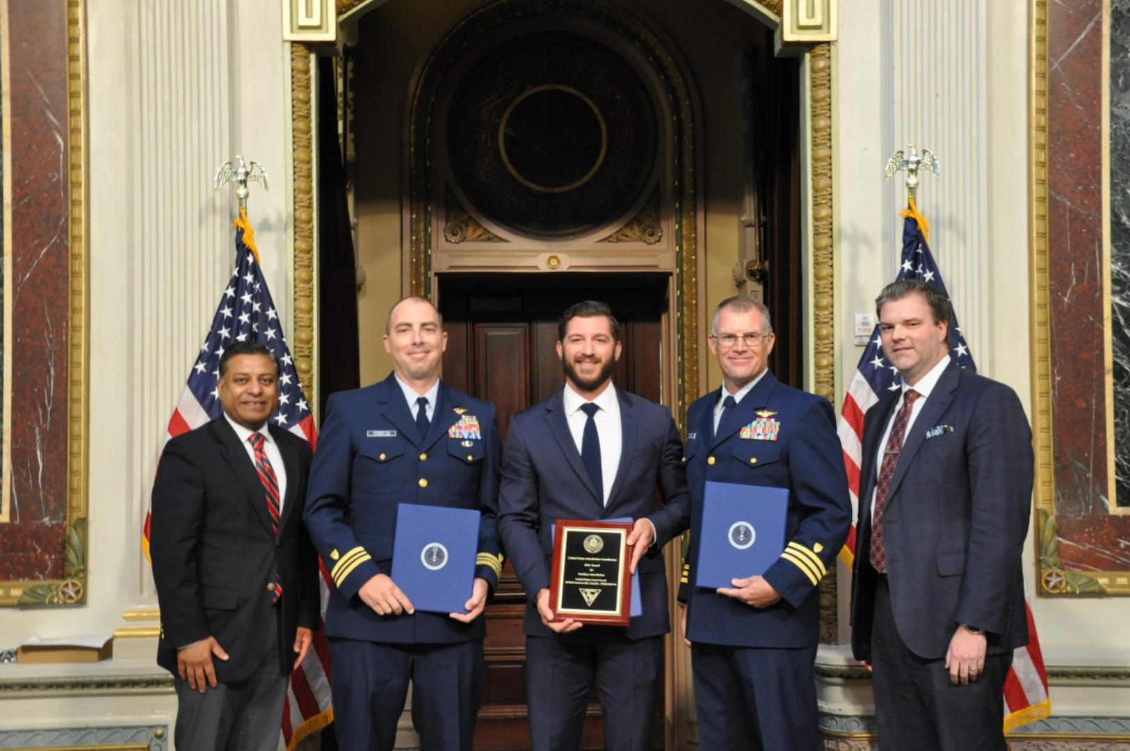 Lt. Cmdr. Samuel Pemberton (left), Petty Officer 2nd Class James Peragine, and Lt. Cmdr. Matthew Van Ginkel, the Endgame59 aircrew, received the U.S. Interdiction Maritime Interdiction Award Feb. 18, 2022, for their successful interdiction mission in August 2021. (USCG photo)