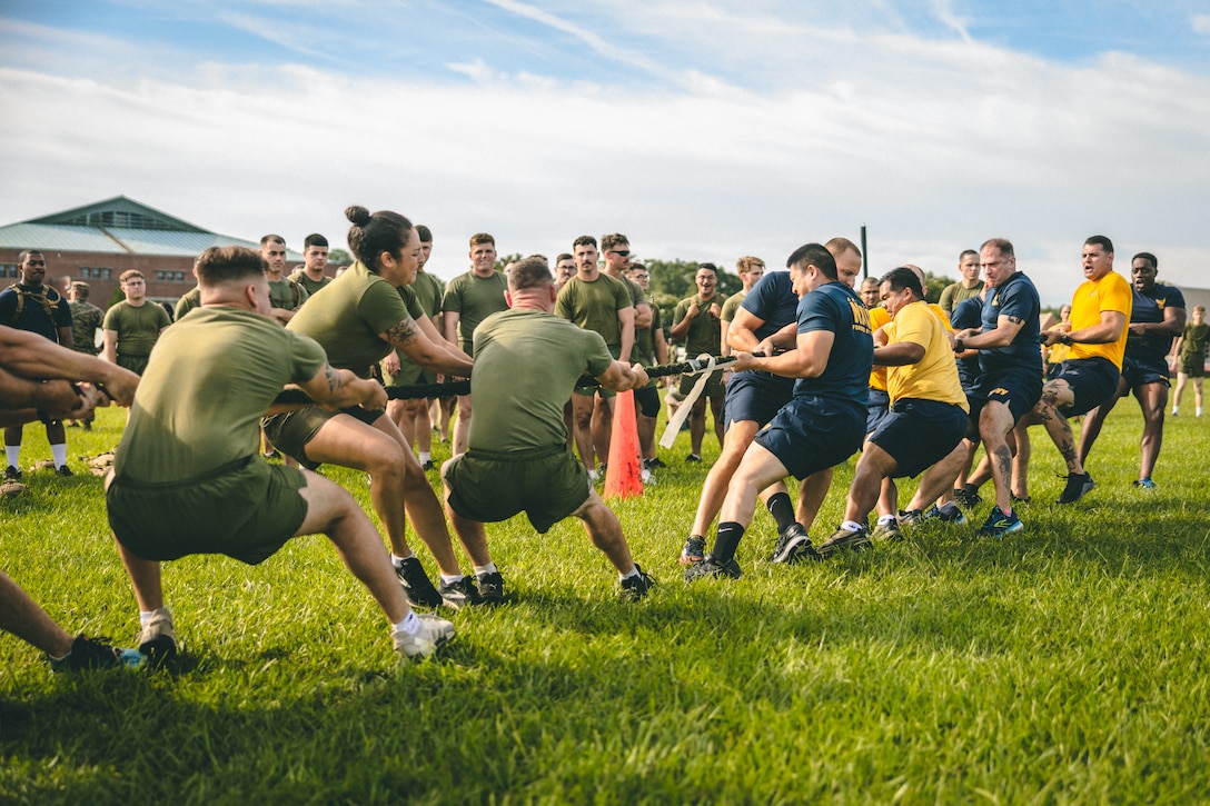 U.S. Marines and Sailors with 2nd Marine Logistics Group play tug-of-war during a field meet at Camp Lejeune, North Carolina, Sep. 1, 2022. 2nd MLG Marines and Sailors participated in the field meet with various athletic events, promoting cohesion, camaraderie, and physical fitness within the unit before the Labor Day holiday weekend.