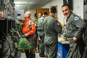 U.S. Air Force 85th Flying Training Squadron members, previous and current, change in the flight room at Laughlin Air Force Base, Texas, on Sept. 2, 2022. The 85th FTS celebrated its 50th anniversary of being reactivated at LAFB. (U.S. Air Force photo by Airman 1st Class Keira Rossman)