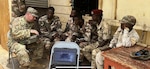 Kentucky National Guard Sgt. Corey Davis, with Joint Force Headquarters, wireless communications, conducts a check on knowledge, Aug. 17, 2022, regarding initial radio setup and functions testing with Djiboutian Armed Forces Bataillon d’Intervention Rapide (BIR).