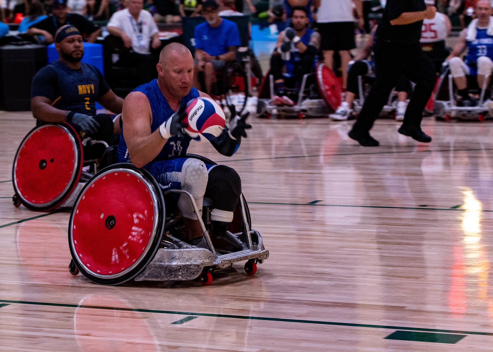 U.S. Air Force Senior MSgt. Benjamin Seekell, a Team Air Force Warrior Games athlete, catches the ball during a wheelchair rugby game at the 2022 Department of Defense Warrior Games, August 21st, 2022, in Orlando, Florida.
