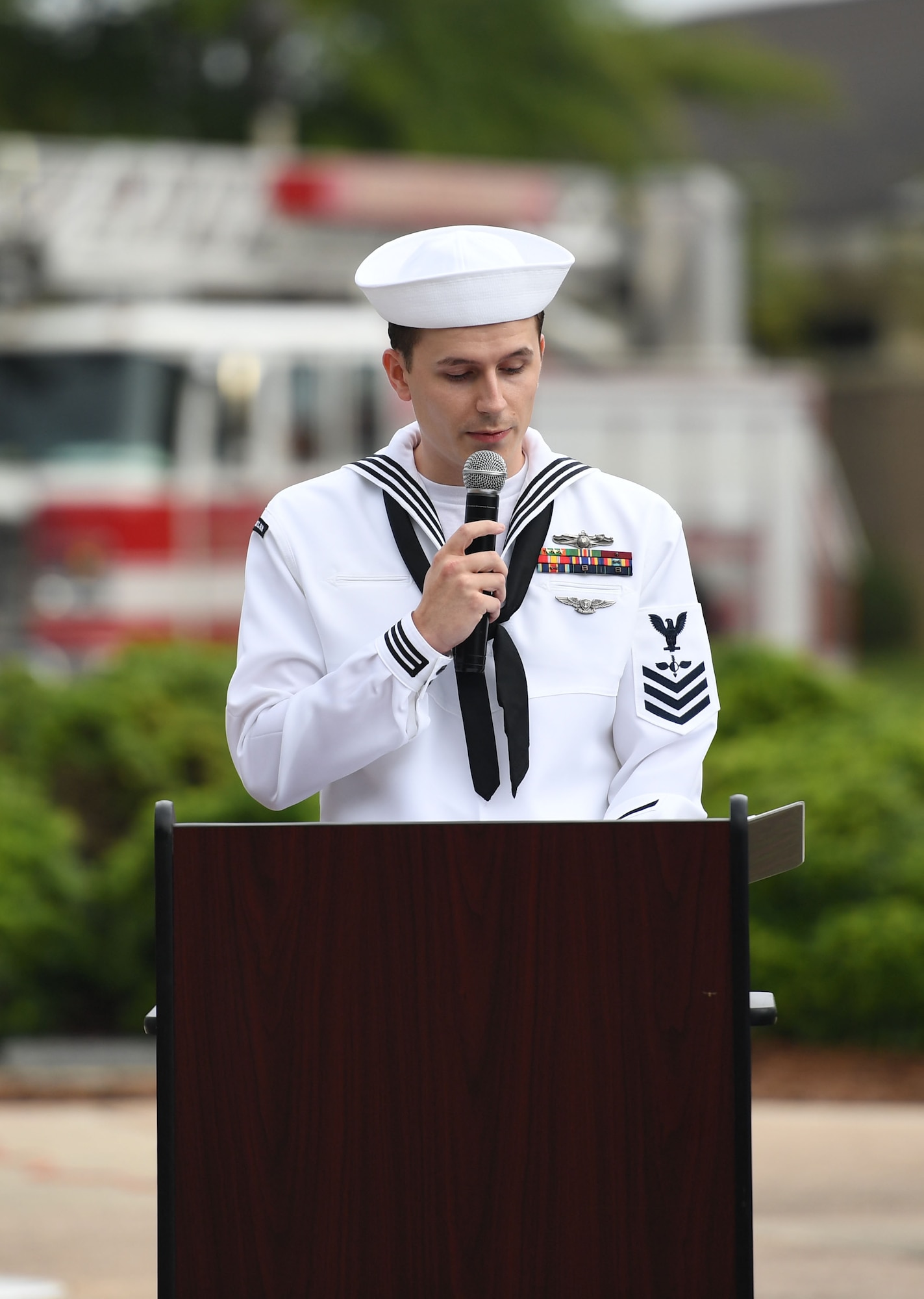 U.S. Navy Aerographers Mate 1st Class Benjamin Grooms, Center for Naval Aviation Technical Training Unit Keesler instructor, delivers remarks during a 9/11 ceremony in front of the 81st Training Wing headquarters building at Keesler Air Force Base, Mississippi, Sept. 9, 2022. The event honored those who lost their lives during the 9/11 attacks. (U.S. Air Force photo by Kemberly Groue)