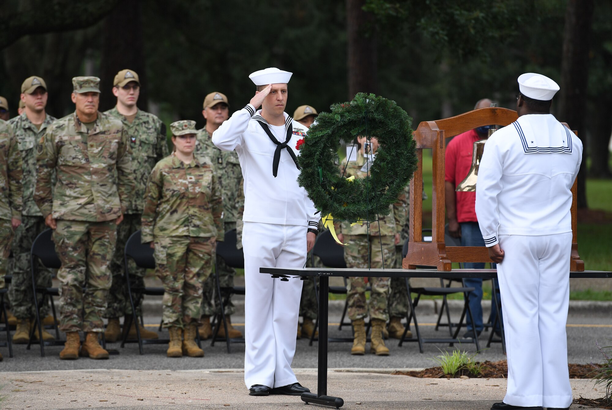 U.S. Navy Aerographers Mate 1st Class Sean Pirmann, Center for Naval Aviation Technical Training Unit Keesler instructor, renders a salute during a 9/11 ceremony in front of the 81st Training Wing headquarters building at Keesler Air Force Base, Mississippi, Sept. 9, 2022. The event honored those who lost their lives during the 9/11 attacks. (U.S. Air Force photo by Kemberly Groue)