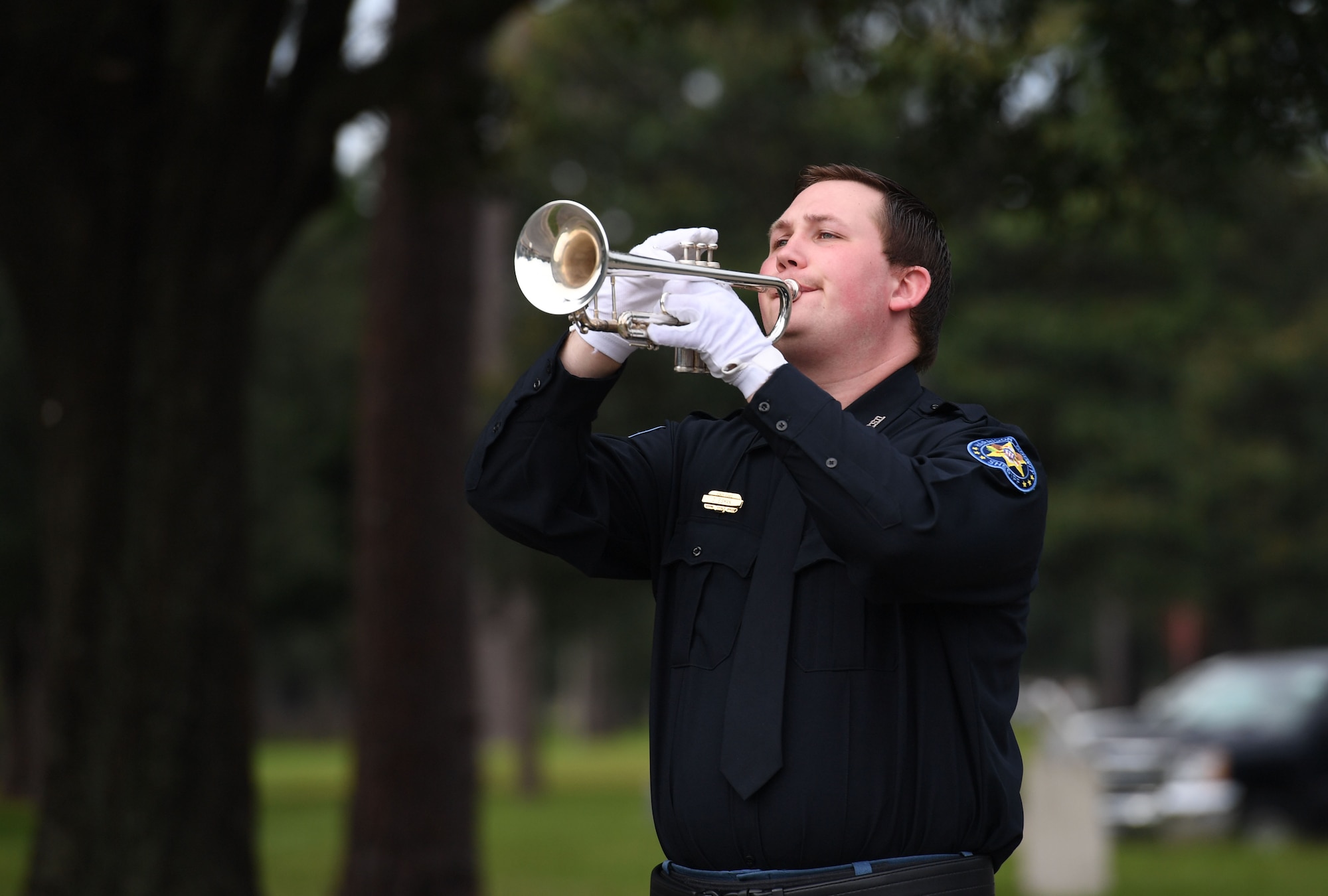 Deputy David Eisman, Harrison County Sheriff's Office deputy, plays Taps on his bugle during a 9/11 ceremony in front of the 81st Training Wing headquarters building at Keesler Air Force Base, Mississippi, Sept. 9, 2022. The event honored those who lost their lives during the 9/11 attacks. (U.S. Air Force photo by Kemberly Groue)