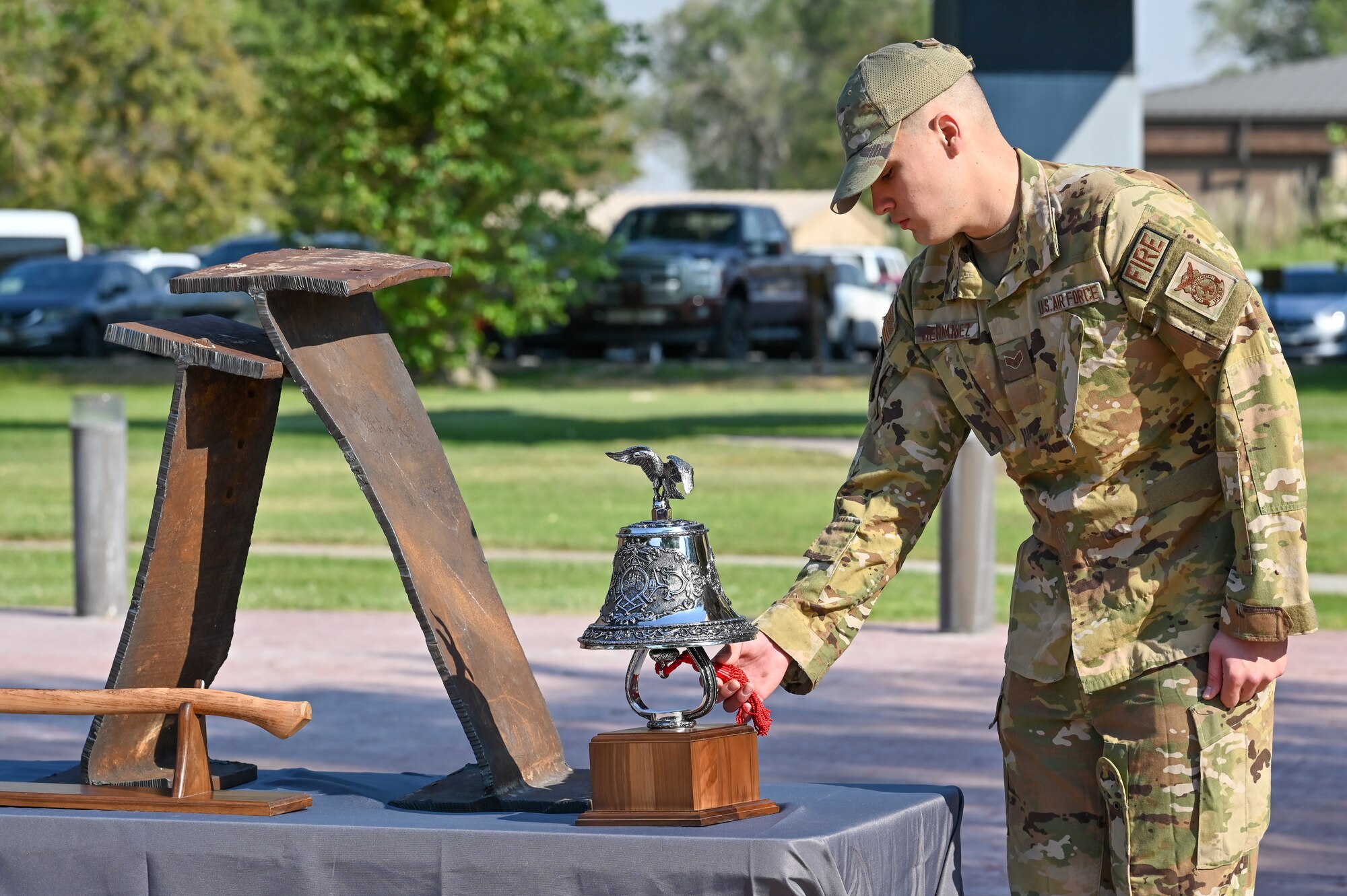 Senior Airman Gilberto Hernandez, 775th Civil Engineering Squadron, rings the bell during the 9/11 Memorial Ceremony Sept. 9, 2022
