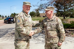 Two military men in uniform shaking hands
