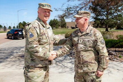 Two military men in uniform shaking hands