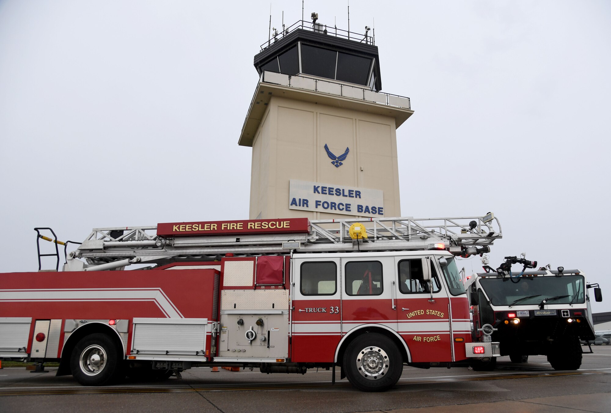 Keesler fire trucks are parked in front of the air traffic control tower during the 9/11 Tower Run at Keesler Air Force Base, Mississippi, Sept. 9, 2022. The event honored those who lost their lives during the 9/11 attacks. (U.S. Air Force photo by Kemberly Groue)