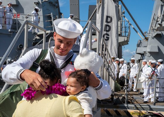 NORFOLK (Sept. 9, 2022) A Sailor assigned to the Arleigh Burke-class guided-missile destroyer USS Cole (DDG 67), embraces his family after returning to Naval Station Norfolk after a regularly scheduled deployment in the U.S. 6th Fleet area of operations in support of theater security cooperation efforts and to defend U.S., allied and partner interests; Sept. 9, 2022. Cole was deployed as part of the Harry S. Truman Carrier Strike Group. (U.S. Navy photo by Mass Communication Specialist 1st Class Ryan Seelbach)