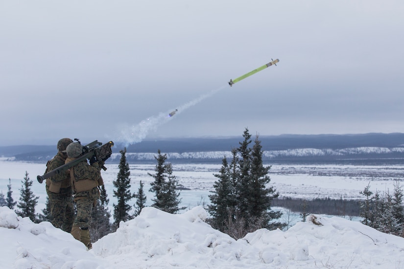 A service member fires a missile in the snow.