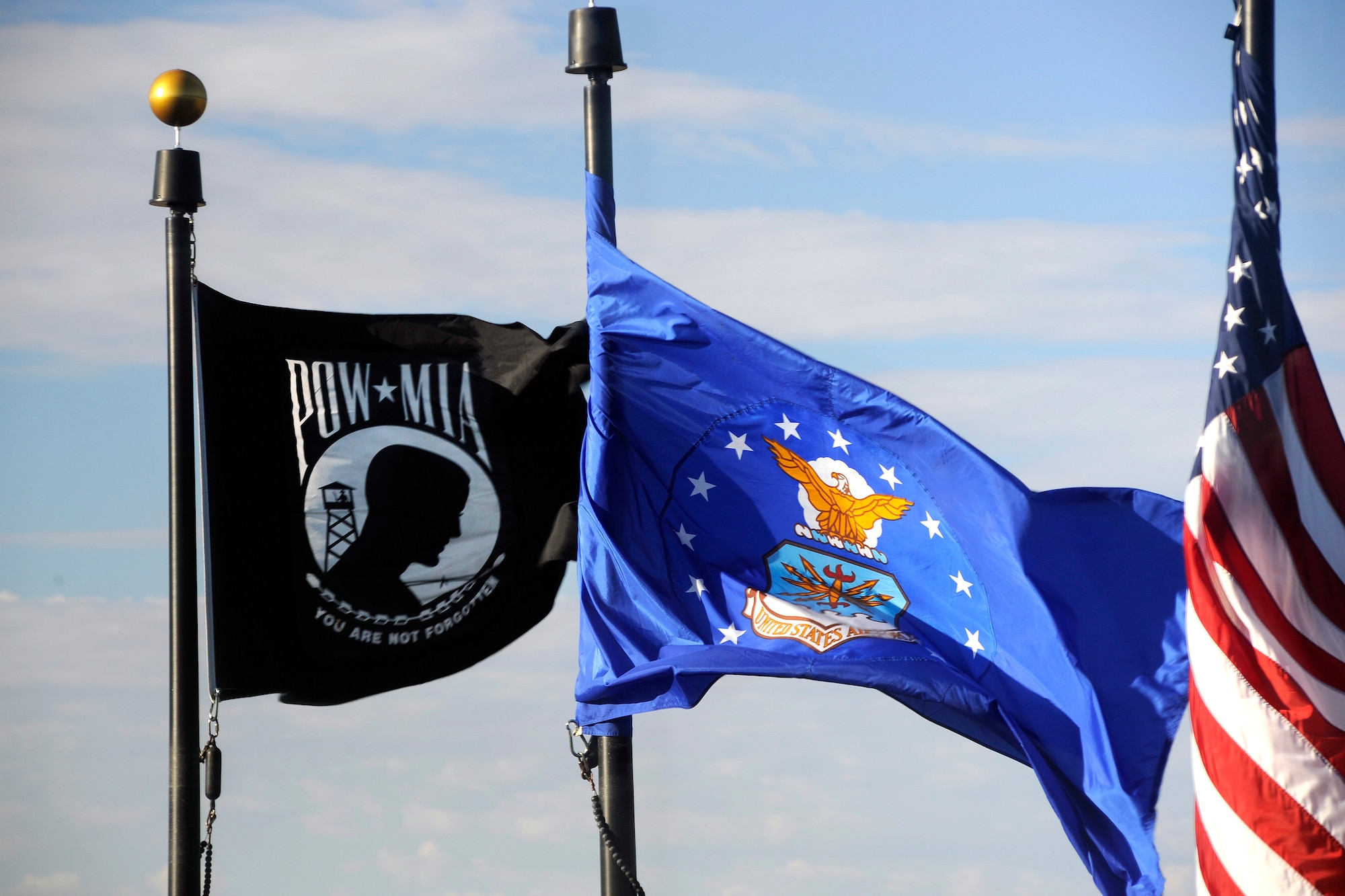 A POW/MIA, Air Force and U.S. flag fly over Schriever Air Force Base, Colo., Sept. 15, 2014, in remembrance of the nation's prisoners of war and missing in action. (U.S. Air Force photo by Dennis Rogers/Released)