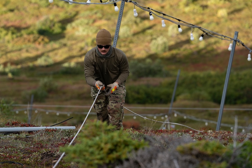 Electricians assigned to the 773d Civil Engineer Squadron perform maintenance work on the star at Mount Gordon Lyon