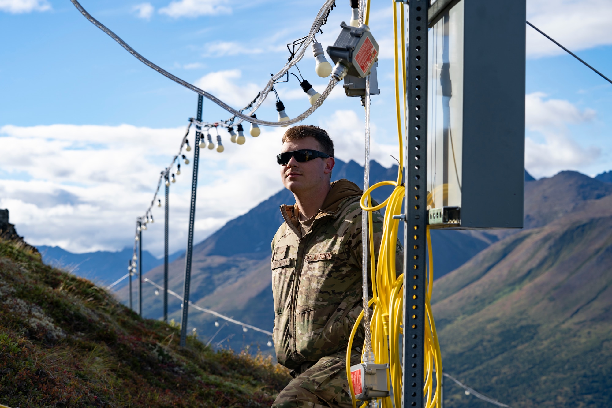 Electricians assigned to the 773d Civil Engineer Squadron perform maintenance work on the star at Mount Gordon Lyon