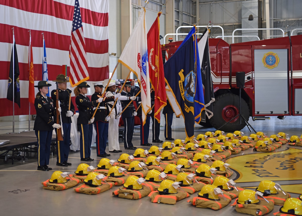 The Goodfellow Air Force Base Joint Service Color Guard presents the colors to begin the 312th Training Squadron’s 9/11 memorial ceremony at the Louis F. Garland Department of Defense Fire Academy high bay, Goodfellow Air Force Base, Texas, Sept. 9, 2022. The 312th TRS placed 56 uniforms and helmets across the floor to signify the 56 fallen DoD firefighters who made the ultimate sacrifice, Sept. 11, 2001. (U.S. Air Force photo by Senior Airman Ethan Sherwood)