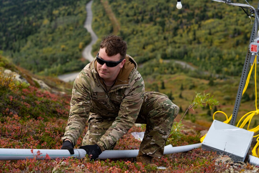 Electricians assigned to the 773d Civil Engineer Squadron perform maintenance work on the star at Mount Gordon Lyon