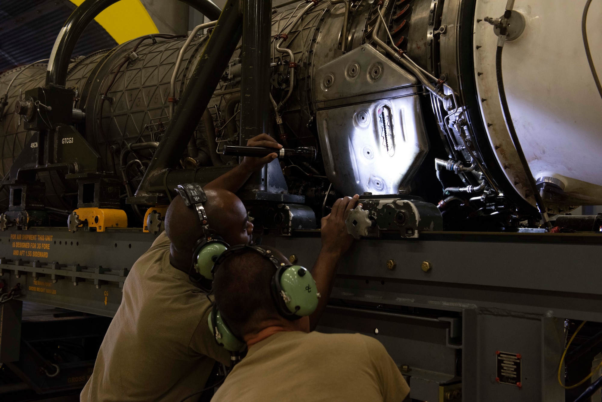 U.S. Air Force Staff Sgt. Samuel Berry, 49th Component Maintenance Squadron test cell craftsman, and Senior Airman Alex Turnage, 49th Component Maintenance Squadron aerospace propulsion journeyman, inspect the oil on a Pratt & Whitney F100 turbofan engine at Holloman Air Force Base, New Mexico, Sept. 6, 2022. The 49th CMS is composed of more than 190 personnel charged with providing top-tier engines that keep Holloman's F-16 Viper pilots in the air. (U.S. Air photo by Airman 1st Class Isaiah Pedrazzini)