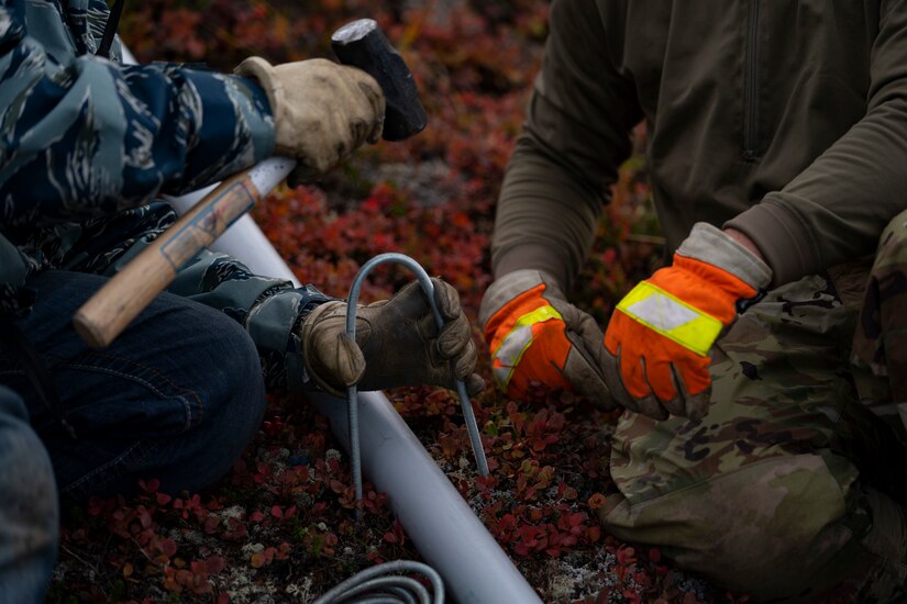 Electricians assigned to the 773d Civil Engineer Squadron perform maintenance work on the star at Mount Gordon Lyon