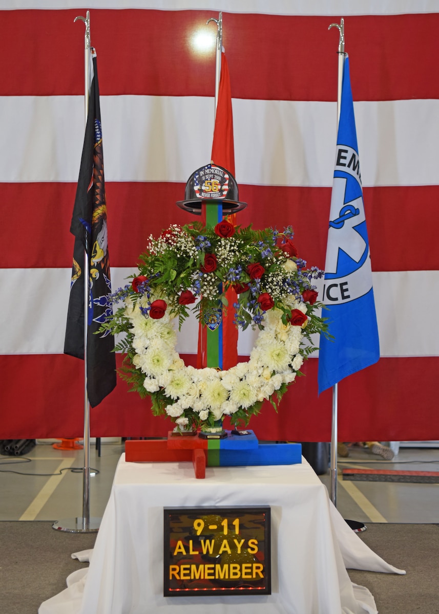 The 9/11 memorial is displayed during the 312th Training Squadron’s remembrance ceremony at the Louis F. Garland Department of Defense Fire Academy high bay, Goodfellow Air Force Base, Texas, Sept. 9, 2022. The helmet represents the 56 fallen DoD firefighters who were killed, Sept. 11, 2001.  The colors on both the wreath and the pole represent the first responders who heroically lost their lives that day. (U.S. Air Force photo by Senior Airman Ethan Sherwood)