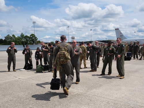 Photo shows Airmen standing around aircraft