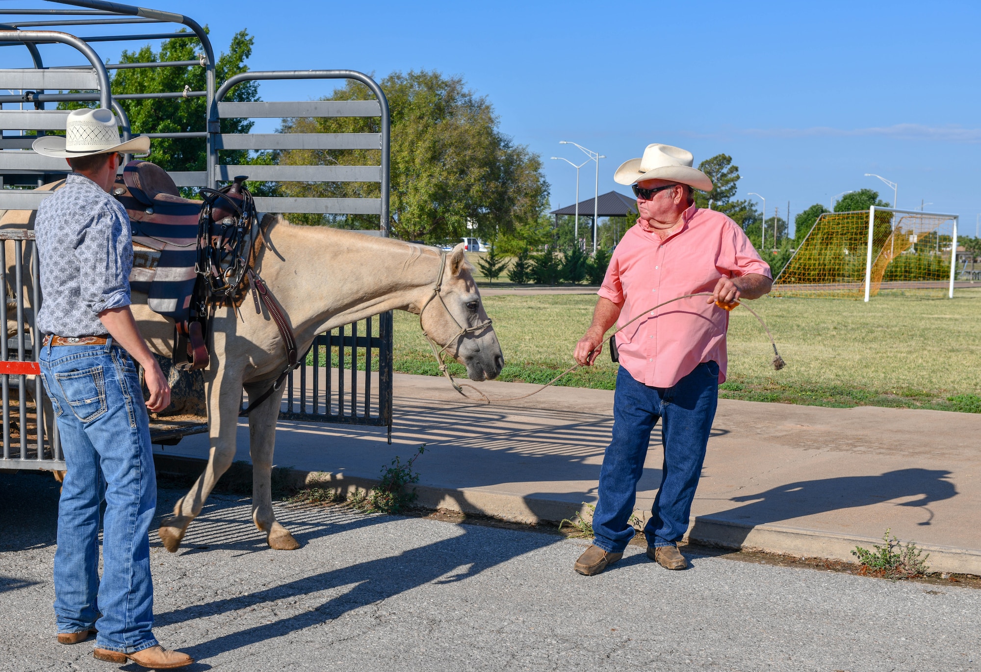 Gary “Bull” Watkins, a friend of Altus since 2011 and rancher, guides a horse off a trailer at Altus Air Force Base, Oklahoma, Aug. 25, 2022. Throughout his life, Watkins has opened multiple businesses in Altus including Altus Texaco, Watkins Auto Parts and a telecommunications business which still exists today. (U.S. Air Force photo by Airman 1st Class Kari Degraffenreed)