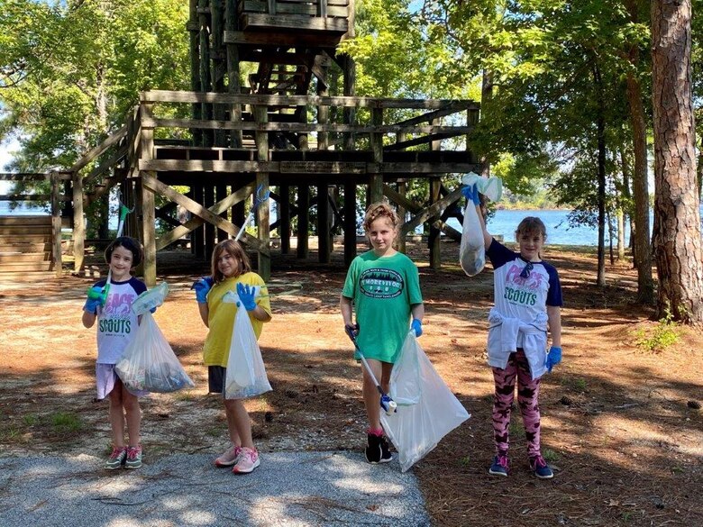 Children pick up trash during a 2021 National Public Lands Day event at J Strom Thurmond Lake. The children collected approximately 220 pounds of trash and cleared 1.75 miles of shoreline. U.S. Army Photo by Susan Miller