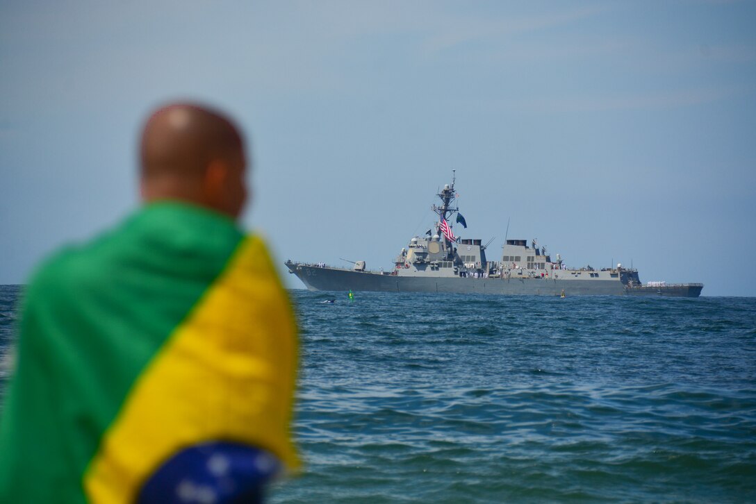 RIO DE JANEIRO, Brazil (Sept. 7, 2022) A man watches the Arleigh Burke-class guided-missile destroyer USS Lassen (DDG 82) pass during the Parade of Ships marking Brazil’s bicentennial during UNITAS LXIII, Sept. 7, 2022.