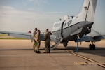 men stand in front of airplane