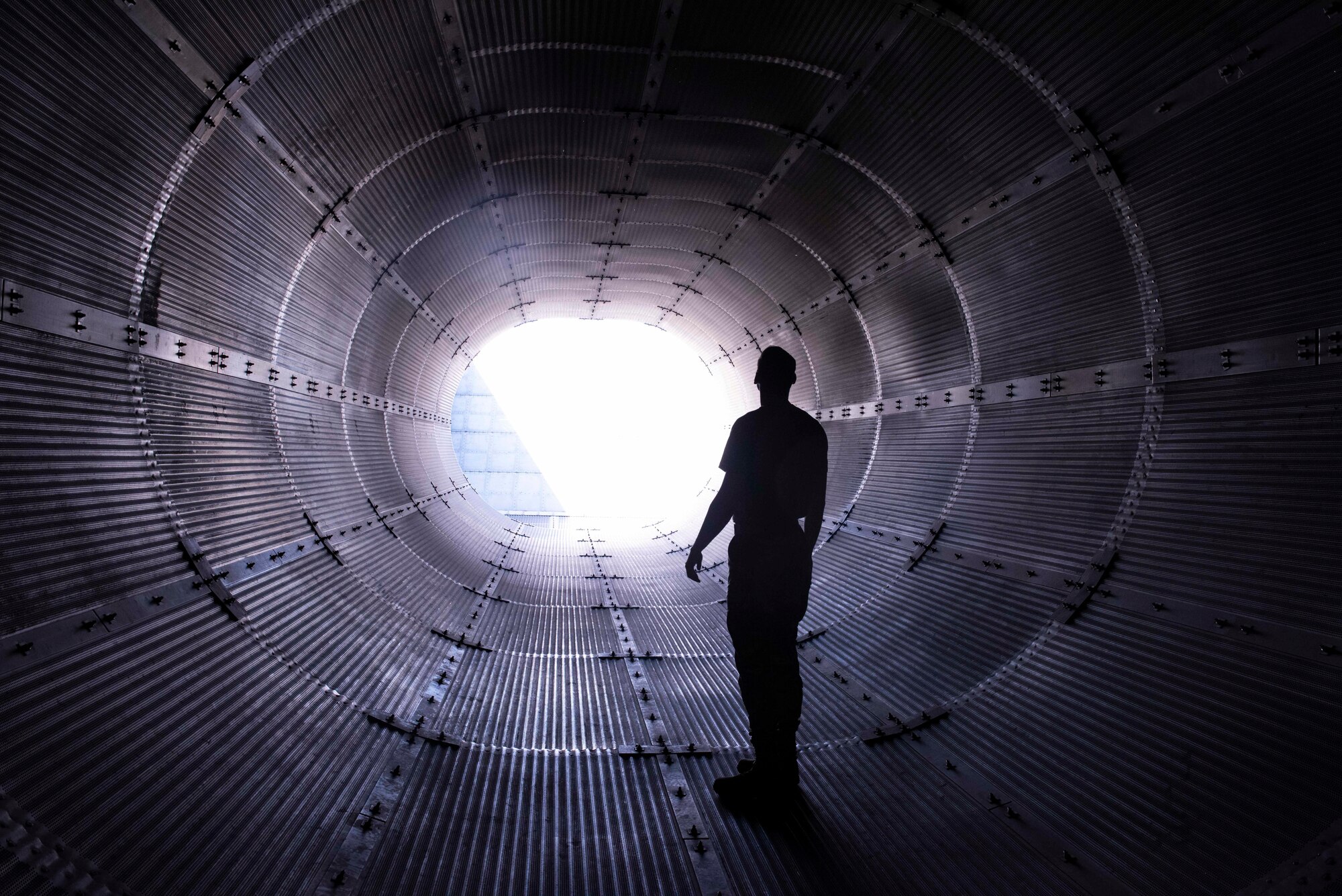 U.S. Air Force 2nd Lt. Collin Kubista,  49th Component Maintenance Squadron propulsion officer-in-charge, examines the exhaust tube of the hush house at Holloman Air Force Base, New Mexico, Sept. 6, 2022. The 49th CMS conducts diagnostic tests in the hush house ensuring aircraft are combat ready. (U.S. Air photo by Airman 1st Class Isaiah Pedrazzini)