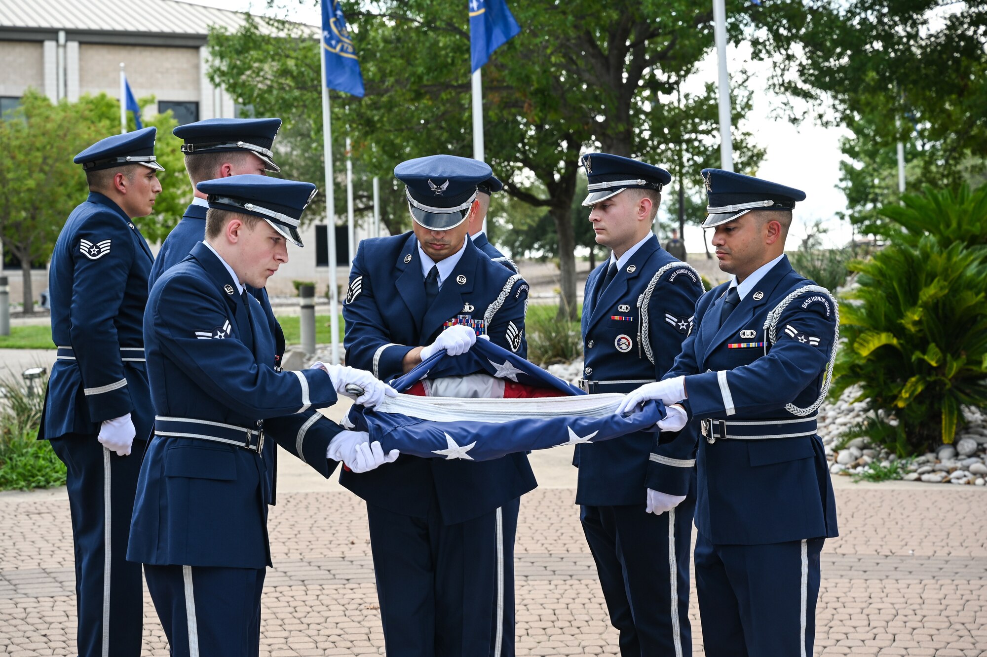 U.S. Air Force base honor guard members fold the American flag during a retreat ceremony at Laughlin Air Force Base, Texas, on Sept. 2, 2022. The 85th FTS celebrated its 50th anniversary at Laughlin which ended with a retreat ceremony. (U.S. Air Force photo by Airman 1st Class Keira Rossman)