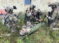 Tactical Air Control Party (TACP) specialists from the 148th Air Support Operations Squadron, a subordinate unit of the 193rd Special Operations Wing in Middletown, Pennsylvania, simulate Tactical Combat Casualty Care (TCCC) and medical evacuation (MEDEVAC) during a training exercise at Fort Indiantown Gap, Pennsylvania, Aug. 24, 2002. The TACP specialists from the 148th ASOS conducted ground operations that simulated capturing an enemy stronghold in hostile territory, while simultaneously integrating the 111th Attack Squadron's MQ-9 Reaper capabilities to provide intelligence, surveillance and reconnaissance as well as armed over watch and close air support. (U.S. Air National Guard photo by Staff Sgt. Wilfredo Acosta, 111th Attack Wing Public Affairs)