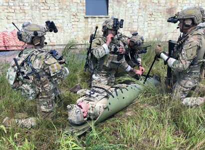 Tactical Air Control Party (TACP) specialists from the 148th Air Support Operations Squadron, a subordinate unit of the 193rd Special Operations Wing in Middletown, Pennsylvania, simulate Tactical Combat Casualty Care (TCCC) and medical evacuation (MEDEVAC) during a training exercise at Fort Indiantown Gap, Pennsylvania, Aug. 24, 2002. The TACP specialists from the 148th ASOS conducted ground operations that simulated capturing an enemy stronghold in hostile territory, while simultaneously integrating the 111th Attack Squadron's MQ-9 Reaper capabilities to provide intelligence, surveillance and reconnaissance as well as armed over watch and close air support. (U.S. Air National Guard photo by Staff Sgt. Wilfredo Acosta, 111th Attack Wing Public Affairs)