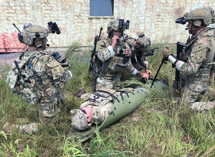 Tactical Air Control Party (TACP) specialists from the 148th Air Support Operations Squadron, a subordinate unit of the 193rd Special Operations Wing in Middletown, Pennsylvania, simulate Tactical Combat Casualty Care (TCCC) and medical evacuation (MEDEVAC) during a training exercise at Fort Indiantown Gap, Pennsylvania, Aug. 24, 2002. The TACP specialists from the 148th ASOS conducted ground operations that simulated capturing an enemy stronghold in hostile territory, while simultaneously integrating the 111th Attack Squadron's MQ-9 Reaper capabilities to provide intelligence, surveillance and reconnaissance as well as armed over watch and close air support. (U.S. Air National Guard photo by Staff Sgt. Wilfredo Acosta, 111th Attack Wing Public Affairs)