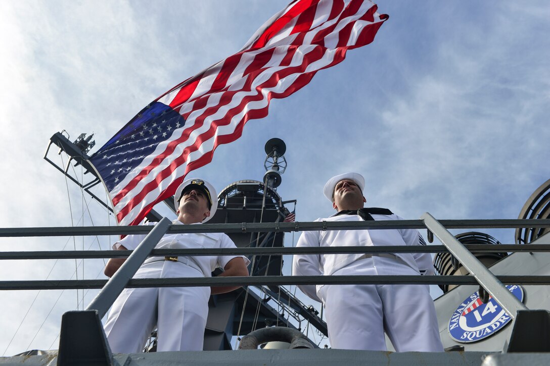Ensign Braeden Wirthwein and Cryptologic Technician Collection 1st Class Tommy Larrieu man the rails aboard USS Lassen (DDG 82) during the Parade of Ships marking Brazil's bicentennial during UNITAS LXIII.