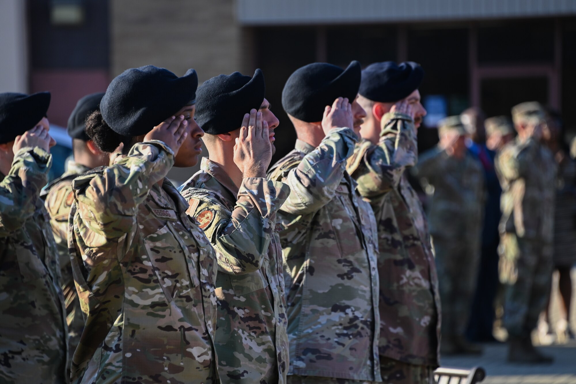 Security Forces Airmen salute while Taps plays during a 9/11 remembrance ceremony at Joint Base Andrews, Md., Sept. 9, 2022.  A member of the Air Force Band played Taps to honor those who lost their lives in the Sept. 11, 2001 terrorist attacks. (U.S. Air Force photo by Airman 1st Class Isabelle Churchill)