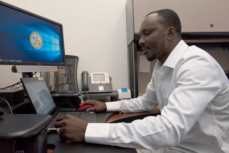 David Tamakloe, auditor with the U.S. Army Corps of Engineers Nashville District Internal Review Office, works at the district’s headquarters in Nashville, Tennessee, Aug. 24, 2022. He shared is life’s journey that led him from a refugee as a child in war-torn Liberia, to immigrating to the United States, to fulfilling his desire to give back to America as an employee of the Corps of Engineers. (USACE Photo by Lee Roberts)