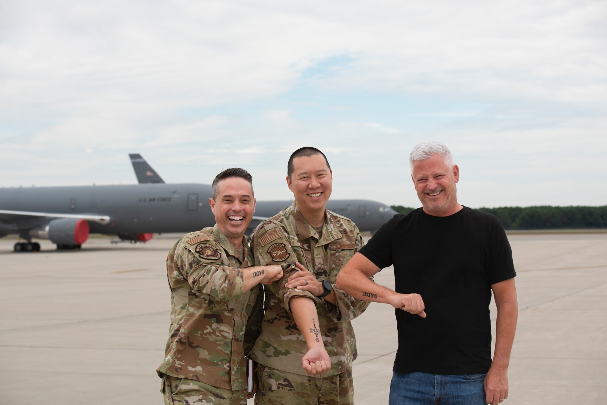 Three leaders share ;IGY6 tattoo on the Pease Air National Guard Base flight line.