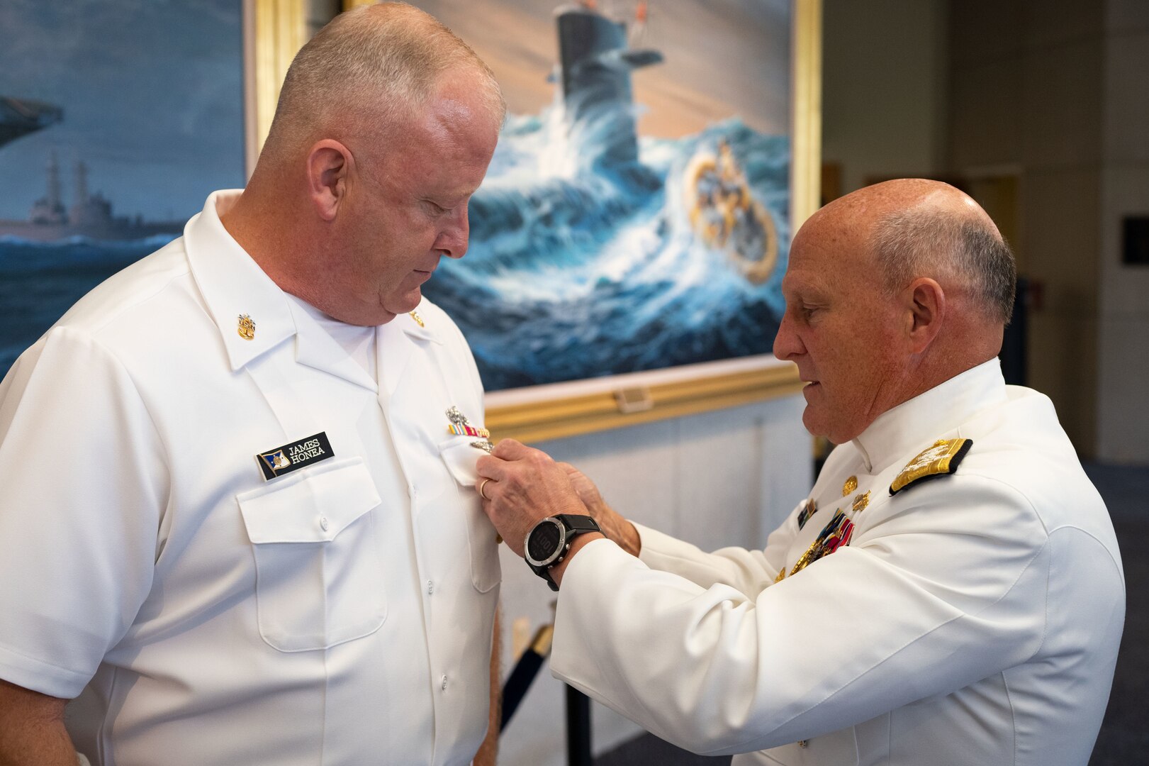 Chief of Naval Operations Adm. Mike Gilday pins Master Chief Petty Officer of the Navy (MCPON) James Honea’s identification badge after delivering the oath of enlistment before the MCPON Change of Office ceremony held at Mahan Hall, United States Naval Academy, Sept. 8, 2022.