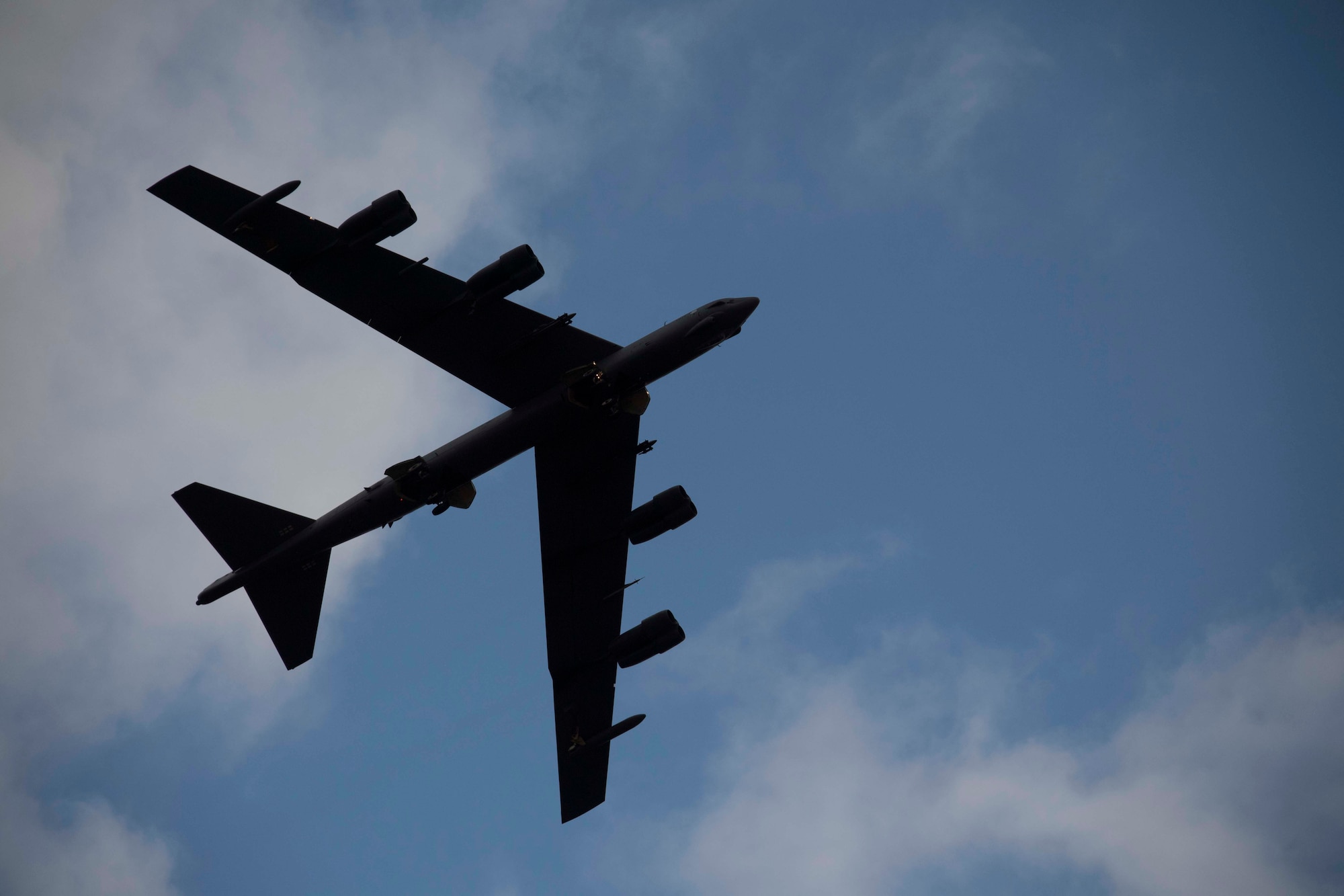 silhouette of a B-52 flying overhead.