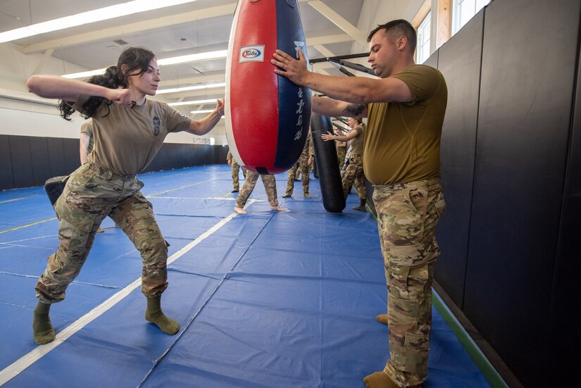 Airman 1st Class Kristina Noe (left), a security forces apprentice with the Kentucky Air National Guard’s 123rd Security Forces Squadron, and Staff Sgt. Richard Kenealy, a squad member of the 123rd SFS, practice hand-to-hand combat at Camp San Luis Obispo, Calif., May 20, 2022. The event was part of law-and-order training completed by more than 20 unit members over six days in central California. (U.S. Air National Guard photo by Phil Speck)