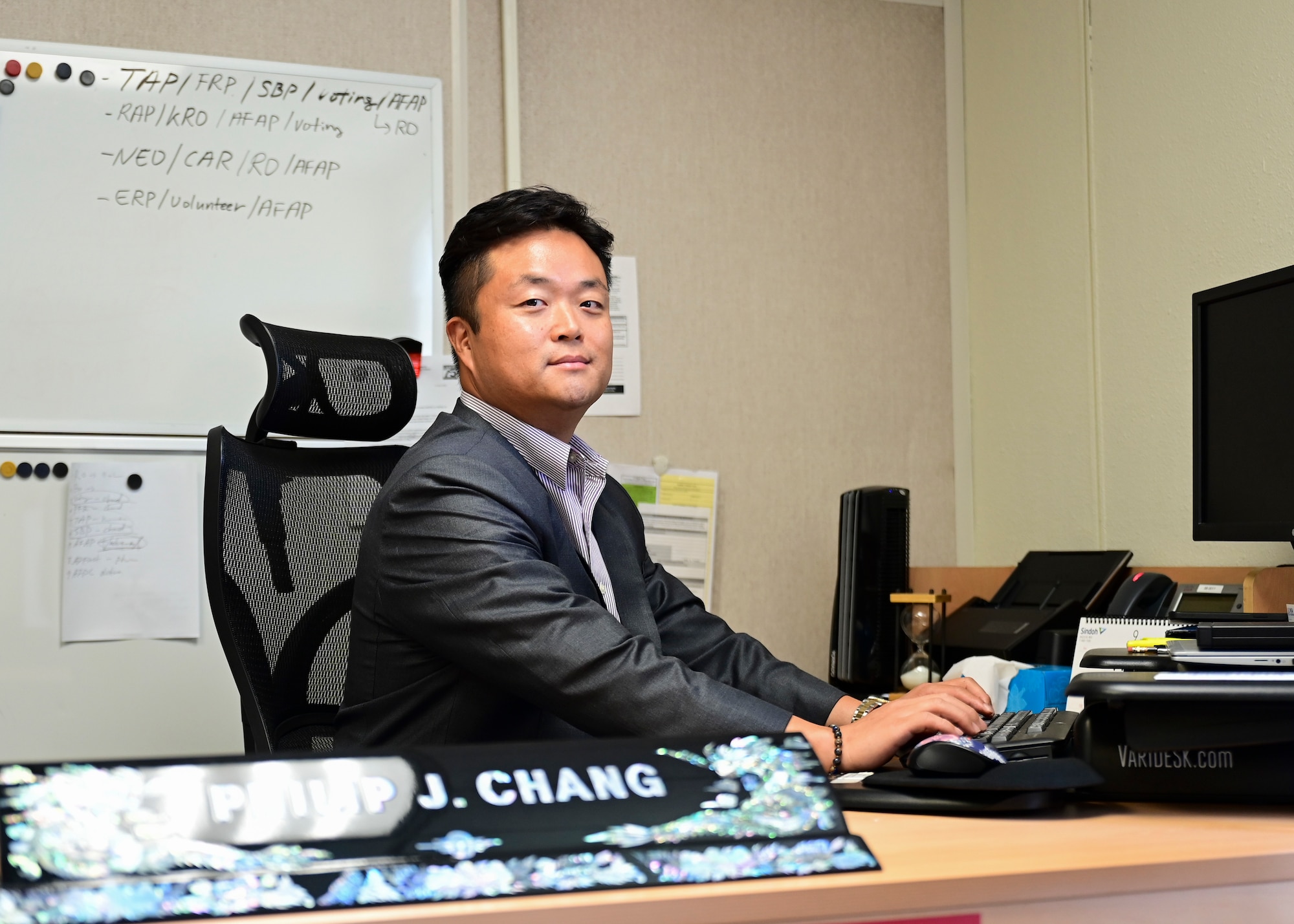 A man sits at a desk