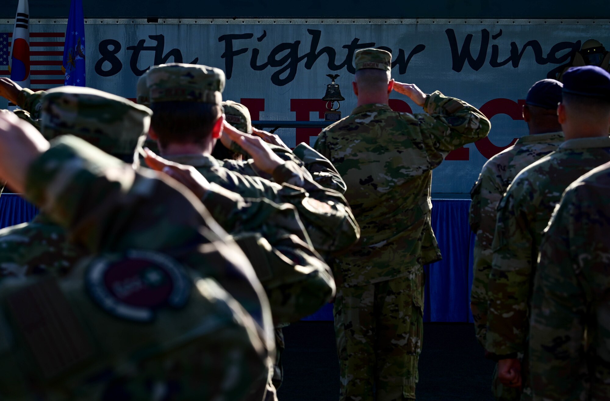 Members from the 8th Civil Engineer Squadron, 8th Security Forces Squadron and 8th Healthcare Operations Squadron salute the ceremonial bell during a 9/11 remembrance ceremony at Kunsan Air Base, Republic of Korea, Sept. 8, 2022. 2,996 individuals tragically lost their lives during the Sept. 11 attacks, 415 of them emergency responders. (U.S. Air Force photo by Senior Airman Shannon Braaten)