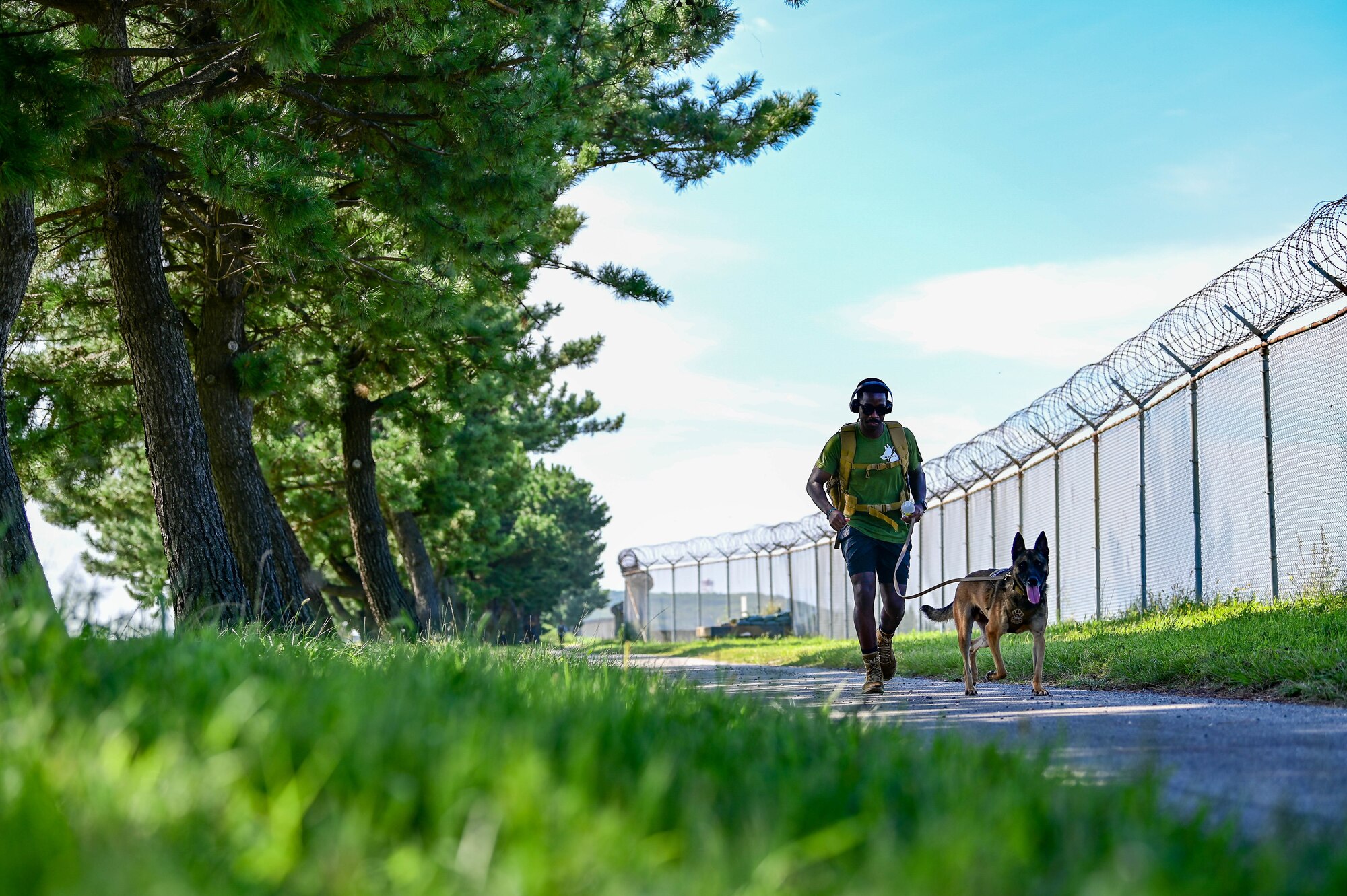 An 8th Security Forces Squadron military working dog handler and dog participate in a ruck march as part of a 9/11 remembrance ceremony at Kunsan Air Base, Republic of Korea, Sept. 8, 2022. The ceremony paid tribute to those that lost their lives during the tragic events of Sept. 11, 2001. (U.S. Air Force photo by Senior Airman Shannon Braaten)