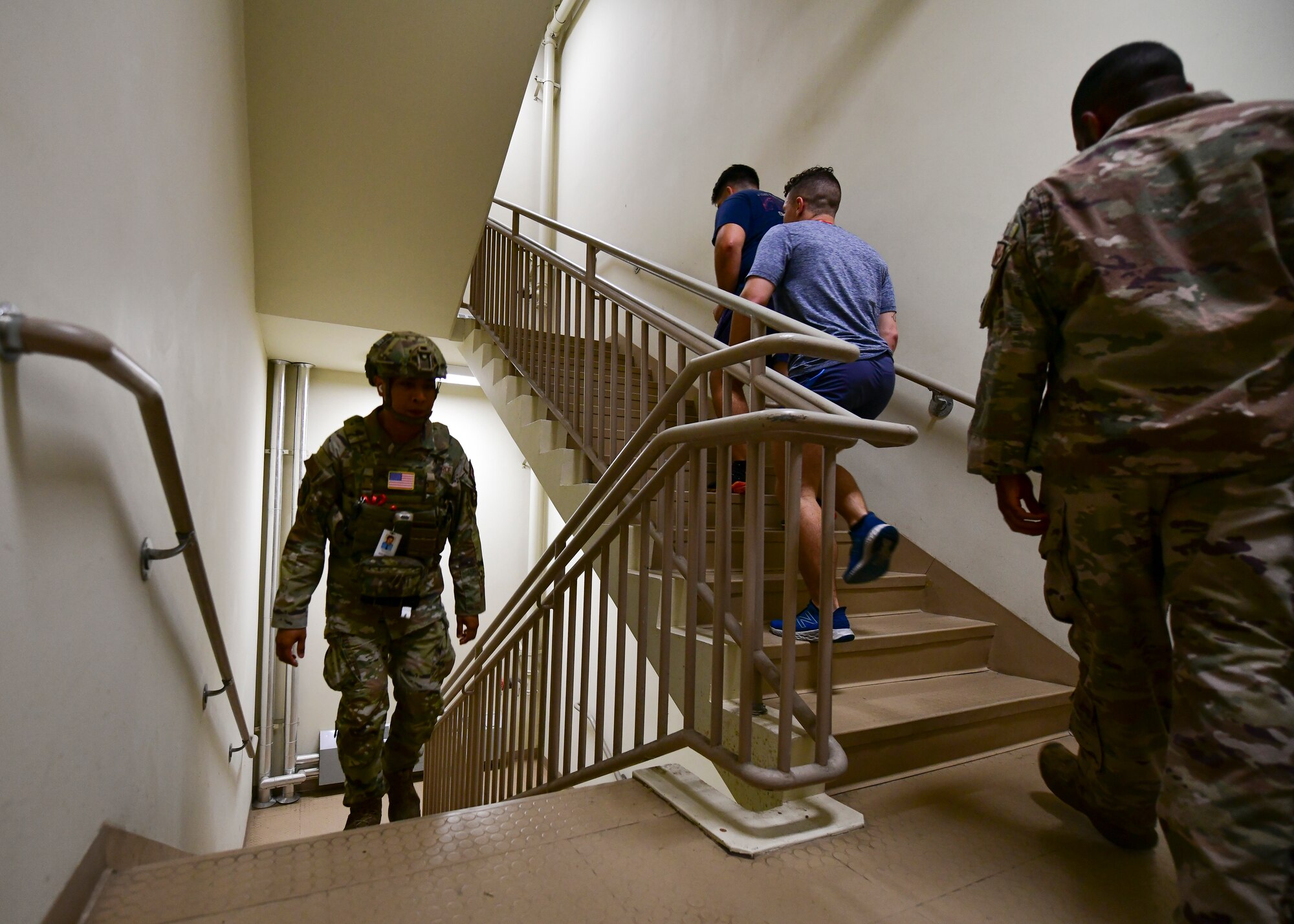 Military firefighters climb stairs