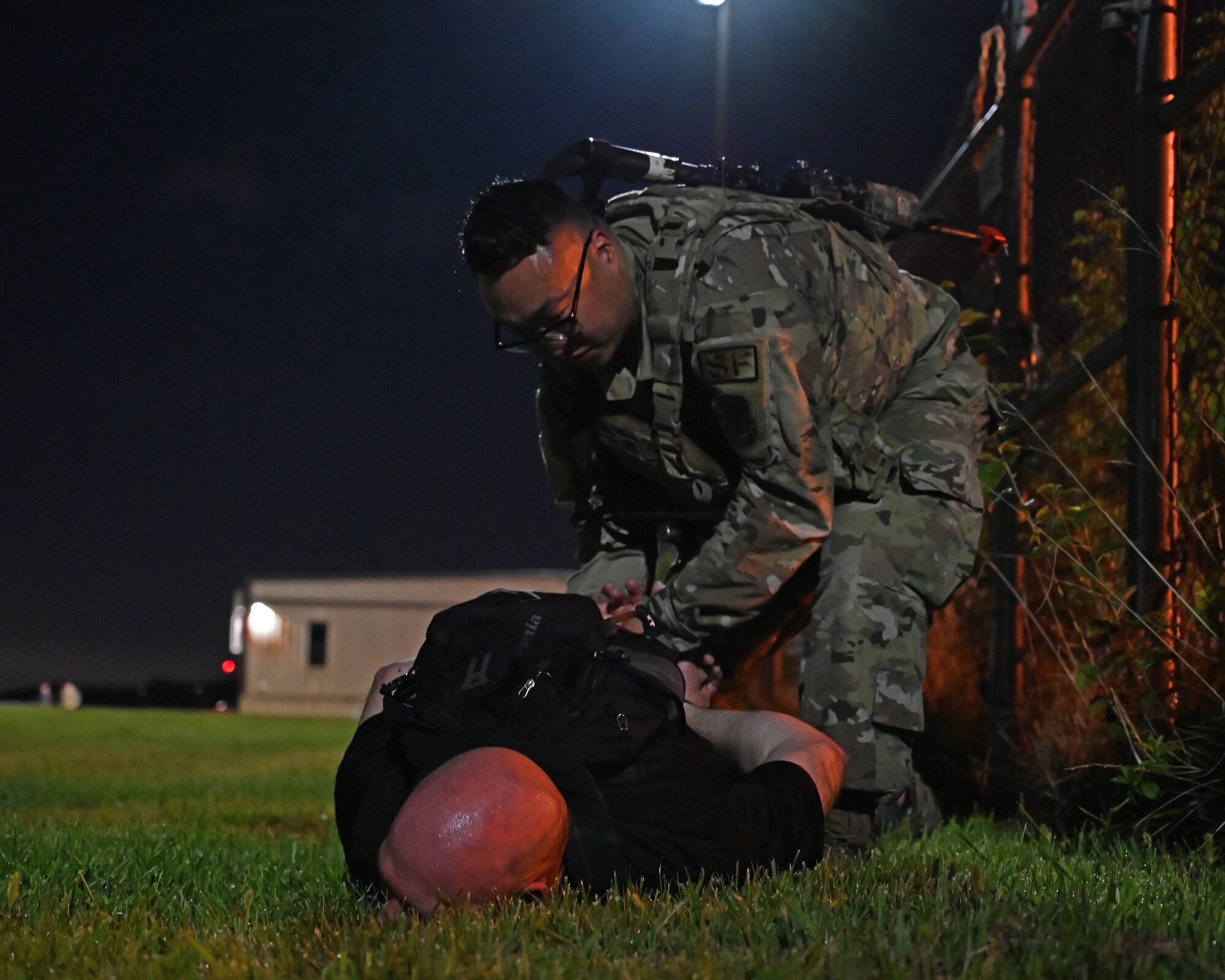 A member of the 175th Security Forces Squadron apprehends a red-team suspect during a simulated attack on Warfield Air National Guard Base at Martin State Airport, Middle River, Md., during an Anti-terrorism/force protection exercise on September 9, 2022.