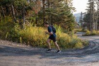 Soldier runs up steep incline along Mt. Mansfield Toll Road.