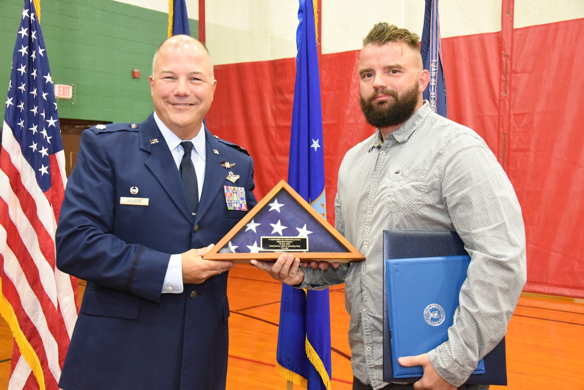 Master Sgt. Mitch Pearson is presented with a flag